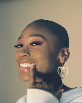 Smiling portrait with a rhinestone Black Lives Matter earring