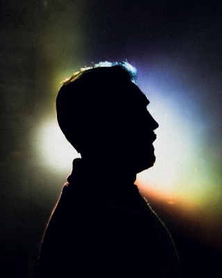 Profile silhouette against multicolored light